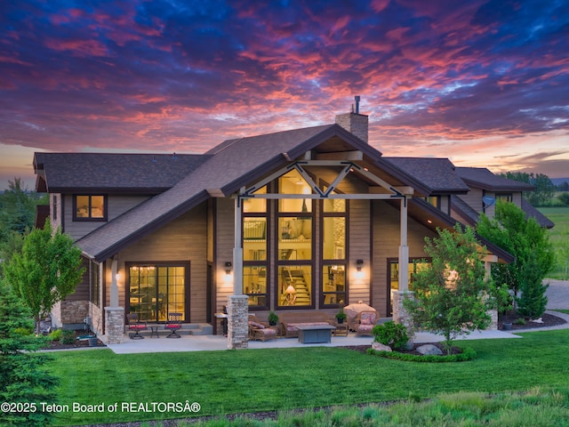 1795 Fumarole Dr, Victor, ID 83455 - rear view of property with a chimney, a patio, a shingled roof, and a lawn