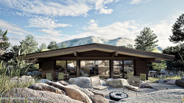 646 Lariat Loop, Jackson, WY 83001 - view of patio / terrace with a mountain view and an outdoor fire pit