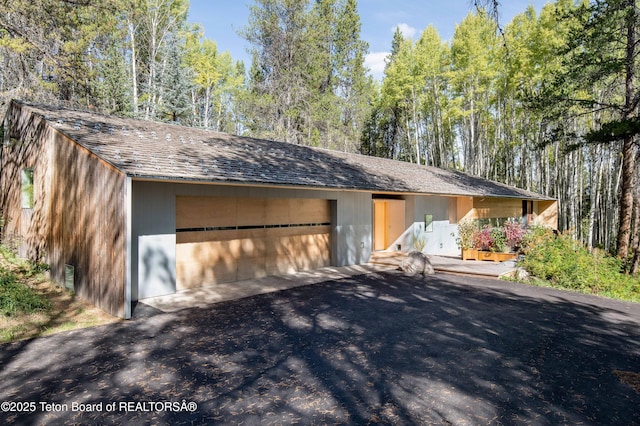 2825 S Sparrow Hawk Rd, Wilson, WY 83014 - view of front facade featuring asphalt driveway and a garage