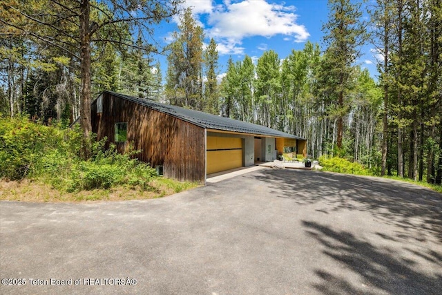 2825 S Sparrow Hawk Rd, Wilson, WY 83014 - garage with driveway and a wooded view