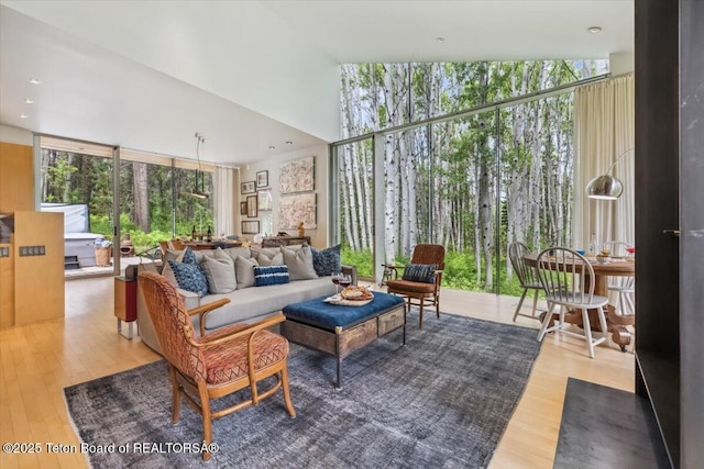 2825 S Sparrow Hawk Rd, Wilson, WY 83014 - living area with wood finished floors, plenty of natural light, a towering ceiling, and expansive windows
