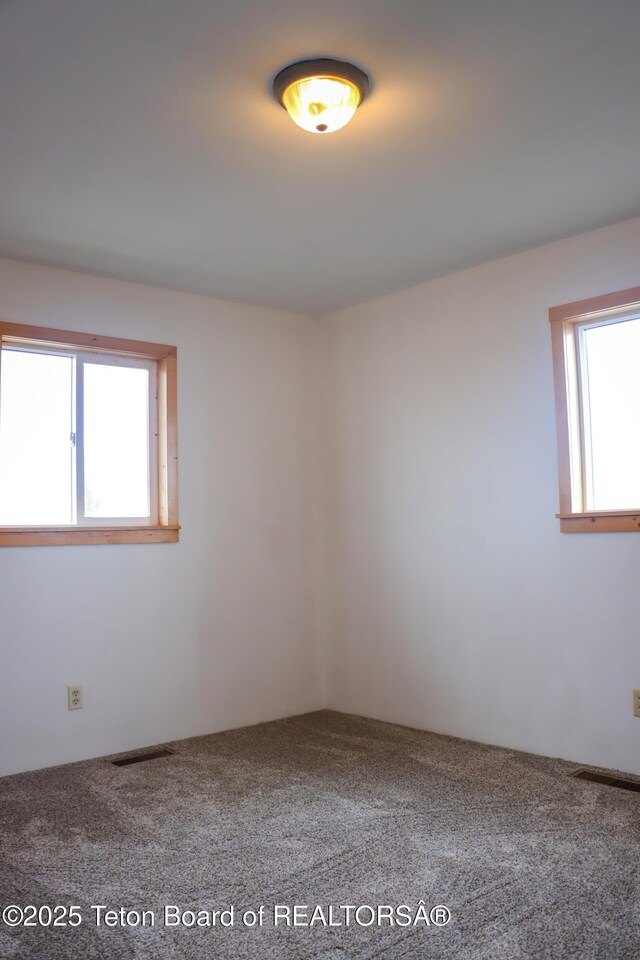 510 Rakestraw Ave, Marbleton, WY 83113 - carpeted empty room with plenty of natural light