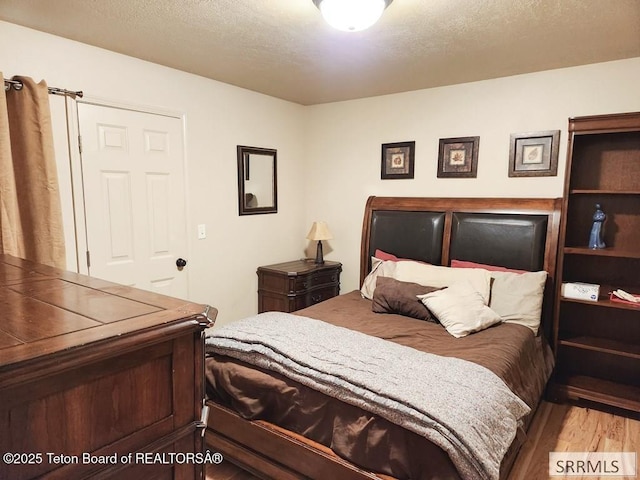 7580 Mountain Laurel Dr Unit A-3, Victor, ID 83455 - bedroom with wood finished floors and a textured ceiling