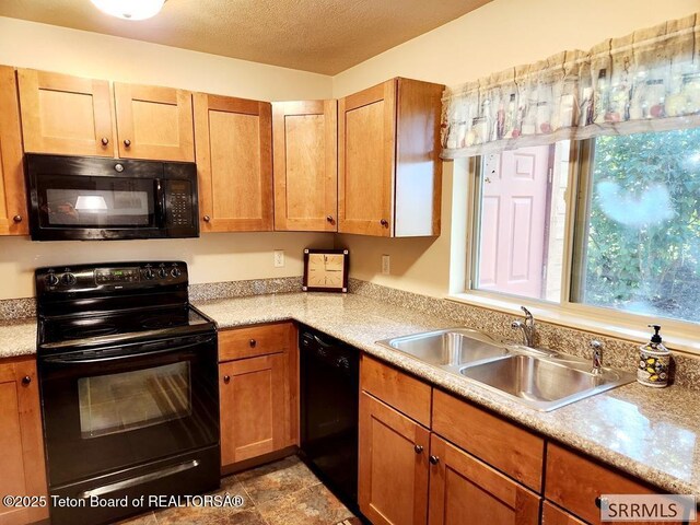 7580 Mountain Laurel Dr Unit A-3, Victor, ID 83455 - kitchen featuring black appliances, a sink, light countertops, and a textured ceiling