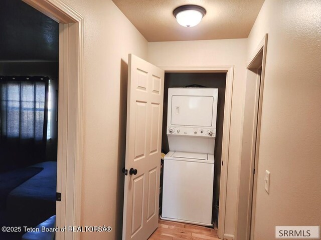 7580 Mountain Laurel Dr Unit A-3, Victor, ID 83455 - washroom with stacked washer and clothes dryer and light wood-style flooring