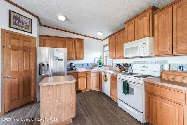 58 Blackhawk Trl, Boulder, WY 82923 - kitchen with white appliances, a sink, ornamental molding, vaulted ceiling, and dark wood-style flooring