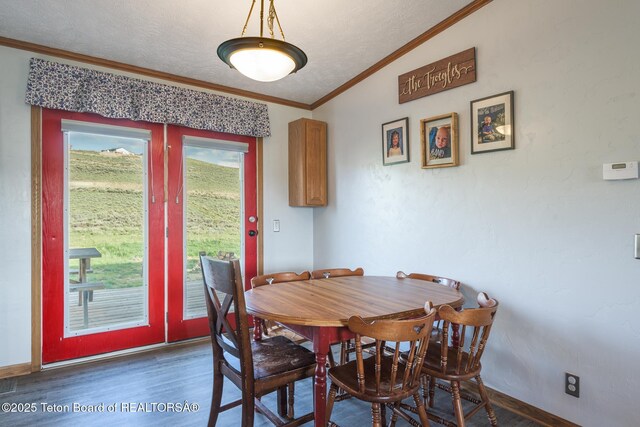 58 Blackhawk Trl, Boulder, WY 82923 - dining space with wood finished floors, ornamental molding, lofted ceiling, and baseboards