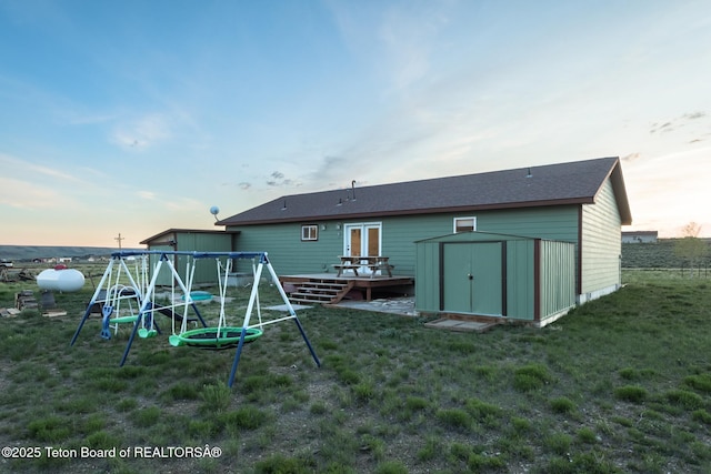 58 Blackhawk Trl, Boulder, WY 82923 - rear view of house featuring a wooden deck, a lawn, and a playground
