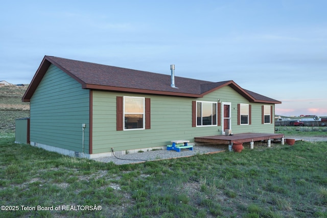 58 Blackhawk Trl, Boulder, WY 82923 - view of front of house featuring a wooden deck and a front lawn