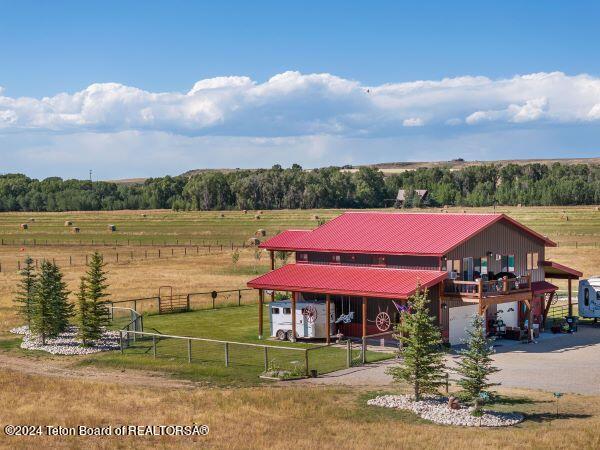 1516 Fischer Ln, Tetonia, ID 83452 - view of front of home featuring a view of countryside, metal roof, and an attached garage