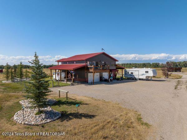 1516 Fischer Ln, Tetonia, ID 83452 - view of front of home featuring a garage and dirt driveway
