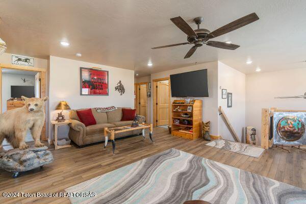1516 Fischer Ln, Tetonia, ID 83452 - living area with wood finished floors, recessed lighting, a ceiling fan, and baseboards