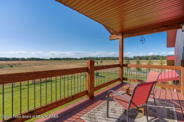 1516 Fischer Ln, Tetonia, ID 83452 - wooden terrace featuring a view of rural / pastoral area and a lawn