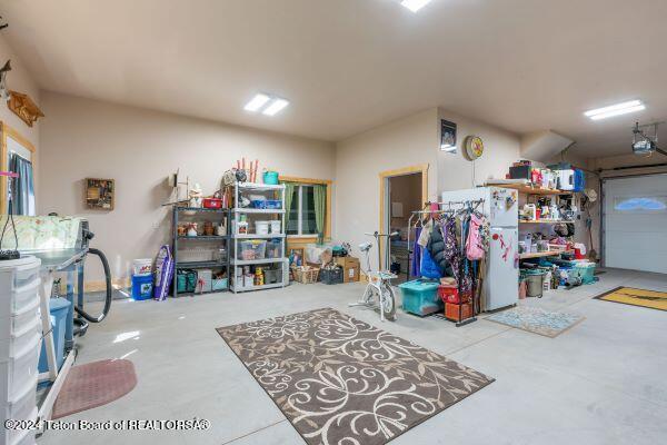 1516 Fischer Ln, Tetonia, ID 83452 - garage featuring freestanding refrigerator and a garage door opener