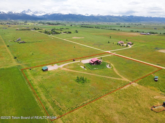 1516 Fischer Ln, Tetonia, ID 83452 - aerial view of sparsely populated area with property parcel outlined, a mountain backdrop, and a pastoral area