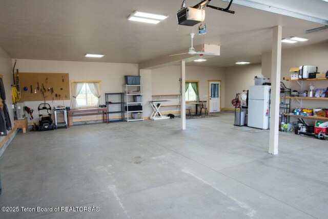 1516 Fischer Ln, Tetonia, ID 83452 - garage featuring freestanding refrigerator and a garage door opener