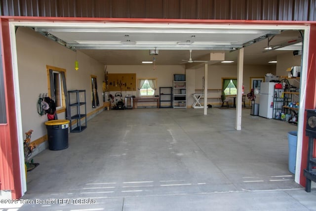 1516 Fischer Ln, Tetonia, ID 83452 - garage with freestanding refrigerator, a garage door opener, and ceiling fan