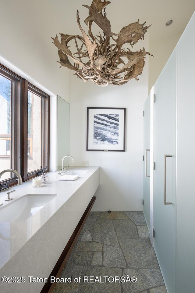 1120 S Thunder Rd, Wilson, WY 83014 - full bath with double vanity and stone finish flooring