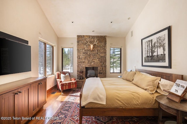 1120 S Thunder Rd, Wilson, WY 83014 - bedroom with wood finished floors, a fireplace, and high vaulted ceiling