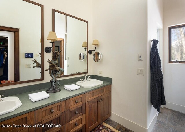 1120 S Thunder Rd, Wilson, WY 83014 - full bathroom featuring double vanity and baseboards