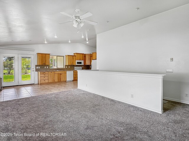 210 E 8th Ave, Afton, WY 83110 - unfurnished living room with a sink, vaulted ceiling, light carpet, ceiling fan, and light tile patterned floors