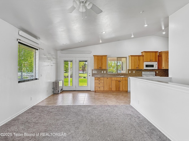 210 E 8th Ave, Afton, WY 83110 - kitchen featuring white appliances, lofted ceiling, heating unit, decorative backsplash, and a ceiling fan