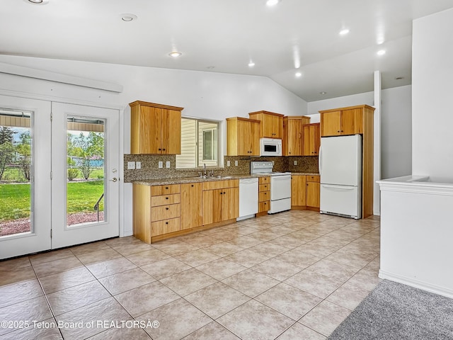 210 E 8th Ave, Afton, WY 83110 - kitchen with white appliances, vaulted ceiling, decorative backsplash, light tile patterned floors, and a sink