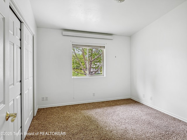 210 E 8th Ave, Afton, WY 83110 - unfurnished bedroom with carpet floors, baseboards, and a closet