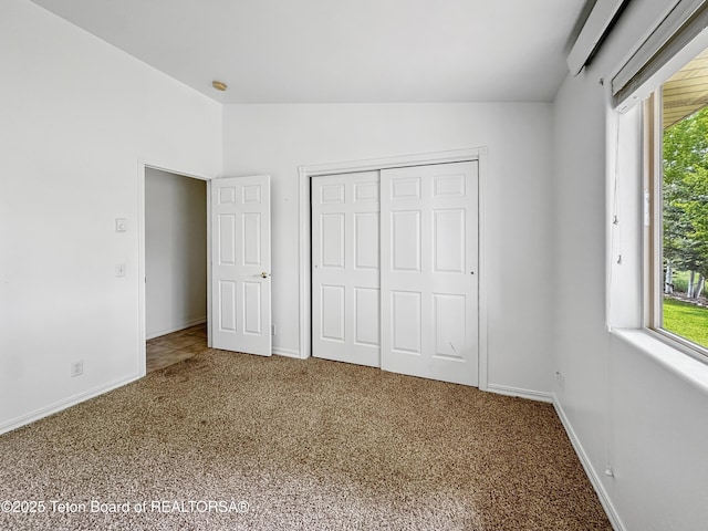 210 E 8th Ave, Afton, WY 83110 - unfurnished bedroom with vaulted ceiling, carpet flooring, baseboards, and a closet