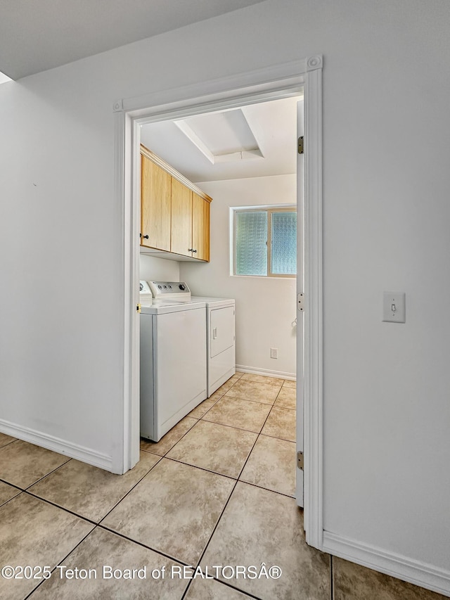 210 E 8th Ave, Afton, WY 83110 - laundry area with cabinet space, washing machine and clothes dryer, light tile patterned flooring, and baseboards