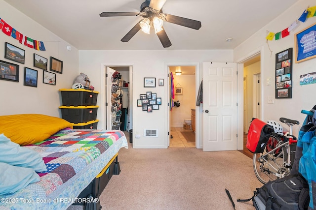 7552 Mountain Laurel Dr Unit D-3, Victor, ID 83455 - bedroom featuring a walk in closet, light carpet, a closet, a ceiling fan, and connected bathroom