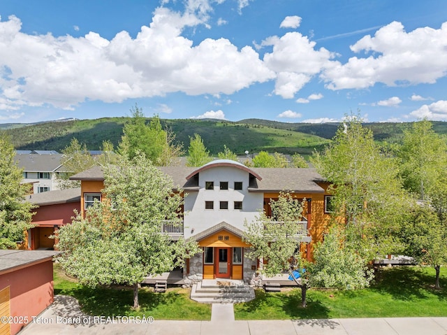 7552 Mountain Laurel Dr Unit D-3, Victor, ID 83455 - view of front facade with a balcony, a mountain view, and stucco siding