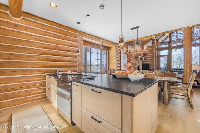 29 Bannock Cir, Victor, ID 83455 - kitchen featuring rustic walls, light wood-style flooring, dark countertops, light brown cabinetry, and recessed lighting