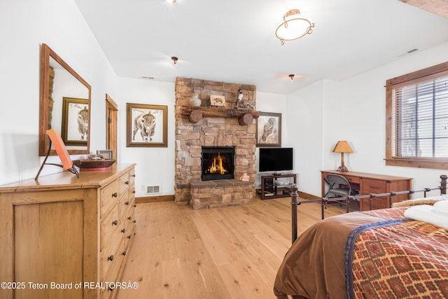 29 Bannock Cir, Victor, ID 83455 - bedroom featuring light wood-type flooring, a stone fireplace, and baseboards