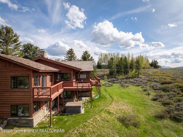 195 W Wolf Dr, Jackson, WY 83001 - view of grassy yard with a hot tub and a wooden deck