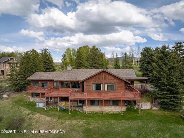 195 W Wolf Dr, Jackson, WY 83001 - rear view of house with a yard, a chimney, and a deck