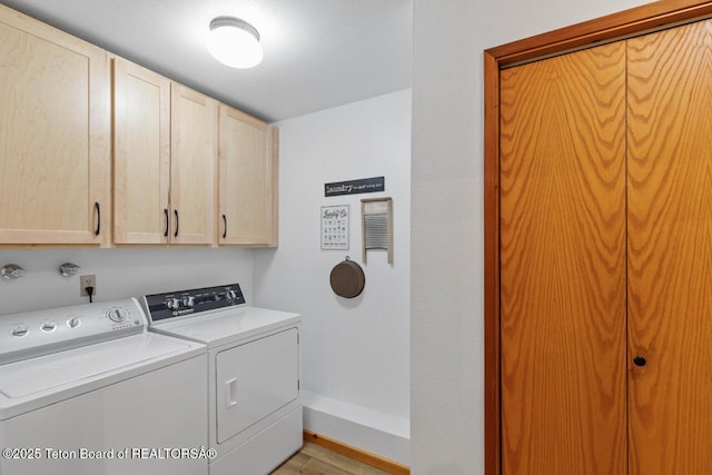 205 Betsy Ct, Bedford, WY 83112 - laundry area with cabinet space, independent washer and dryer, light wood-style flooring, and baseboards