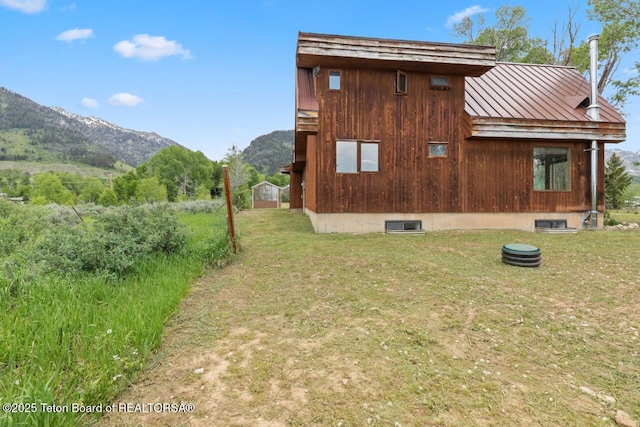 205 Betsy Ct, Bedford, WY 83112 - view of side of property featuring a mountain view, metal roof, a yard, and a standing seam roof