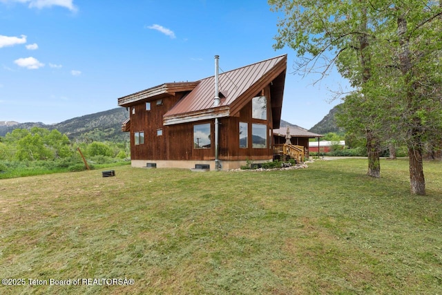 205 Betsy Ct, Bedford, WY 83112 - back of property with a lawn, metal roof, a mountain view, and a standing seam roof