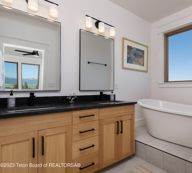 6118 Hatfield Way, Driggs, ID 83422 - full bathroom with double vanity, a freestanding tub, healthy amount of natural light, and tile patterned floors