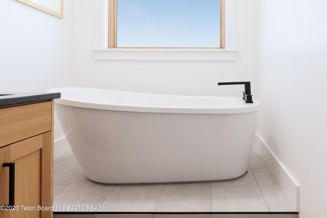 6118 Hatfield Way, Driggs, ID 83422 - bathroom featuring tile patterned floors, vanity, and a freestanding tub