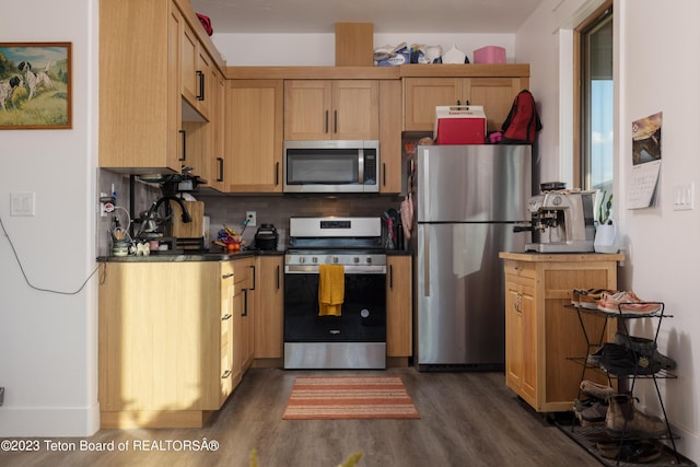 6118 Hatfield Way, Driggs, ID 83422 - kitchen with stainless steel appliances, dark wood-style floors, decorative backsplash, and dark countertops