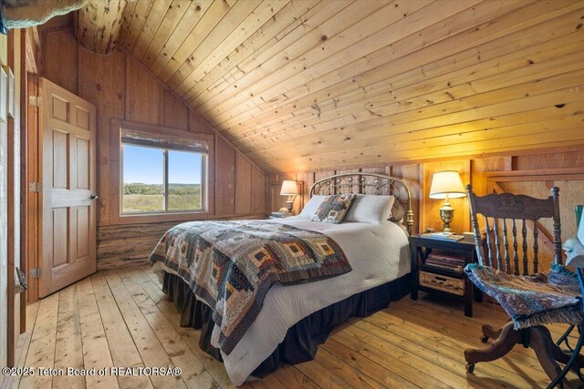 62 Skyline Dr, Bondurant, WY 82922 - bedroom featuring lofted ceiling, light wood-style flooring, wood walls, and wooden ceiling