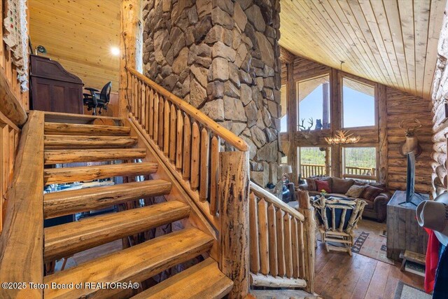 62 Skyline Dr, Bondurant, WY 82922 - stairway featuring wooden ceiling, log walls, high vaulted ceiling, hardwood / wood-style floors, and a wood stove