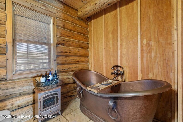 62 Skyline Dr, Bondurant, WY 82922 - bathroom with rustic walls and a freestanding bath