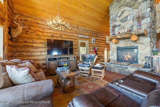 62 Skyline Dr, Bondurant, WY 82922 - living room featuring rustic walls, a stone fireplace, a chandelier, a towering ceiling, and wood finished floors