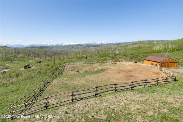 62 Skyline Dr, Bondurant, WY 82922 - view of yard featuring a view of rural / pastoral area, an outdoor riding arena, an outdoor structure, a mountain view, and an exterior structure