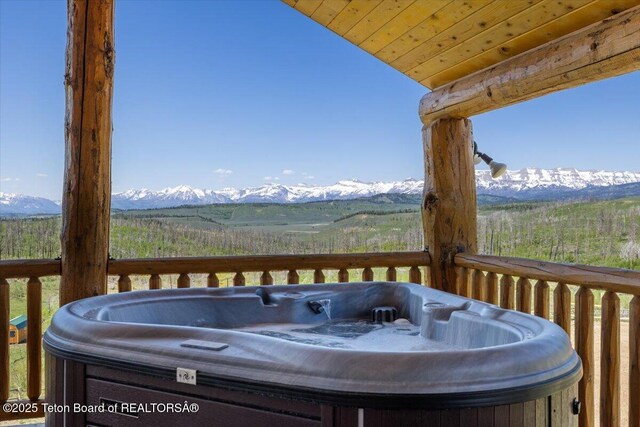 62 Skyline Dr, Bondurant, WY 82922 - wooden deck with a hot tub and a mountain view
