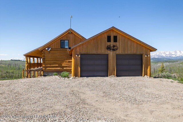 62 Skyline Dr, Bondurant, WY 82922 - view of front of home with a mountain view, log exterior, and a garage