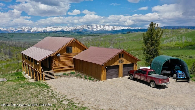 62 Skyline Dr, Bondurant, WY 82922 - log home featuring a garage, a mountain view, log exterior, and metal roof